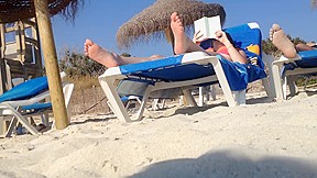 Brunette's candid feet at the beach
