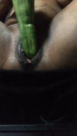 Milf playing with a cucumber