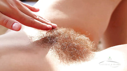"Sexy model Audrey strips down showing off her hairy pussy"