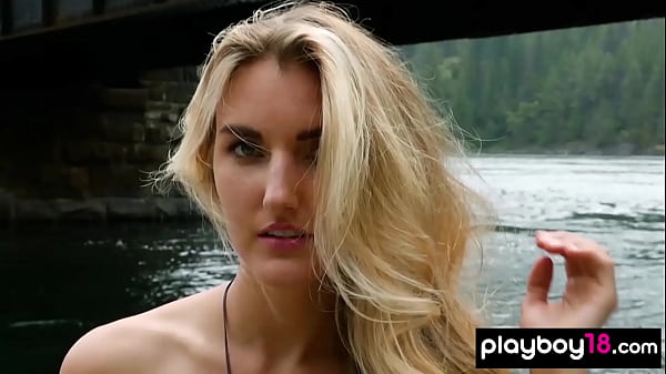 Blonde naked Canadian musician Anna Katarina playing on her guitar outdoor