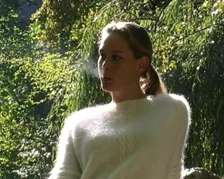 Lady with fluffy sweater smokes