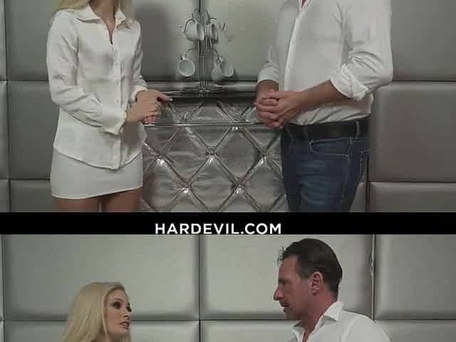 Striking blond Candee Licious takes a phone break from her tedious office job