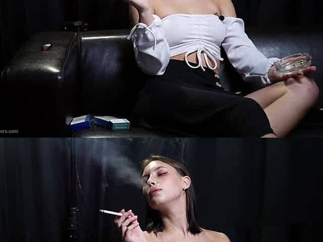 Elegant Brunette Smoking Cigarette in Dark Studio Scene