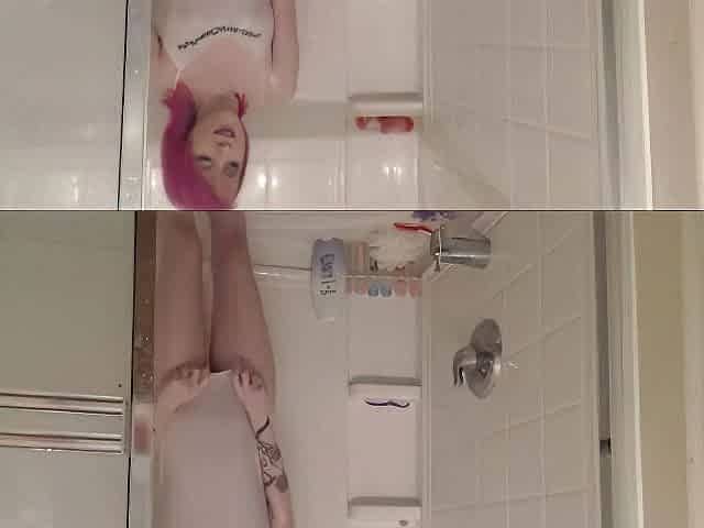 pink hair alt camgirl disrobes and screws cunt in the shower