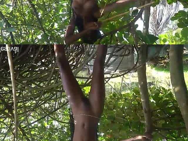 Nude slender tribe woman making a bend to go hunting