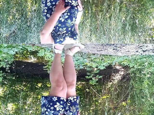Peeing standing throughout pink pants in nature