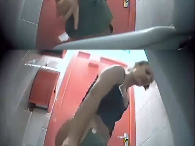 Fit woman in little shorts pees in a public toilet