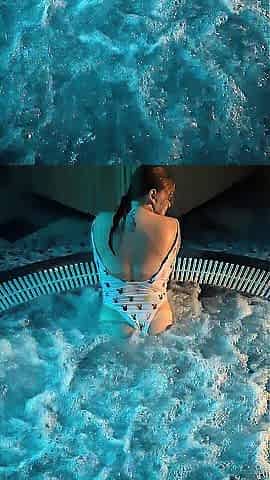Older woman with big melons shows off her charms in the jacuzzi