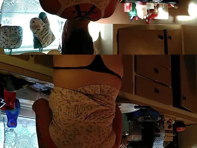 Showing off my cleavage and belt by lifting up my costume whilst cooking in kitchen