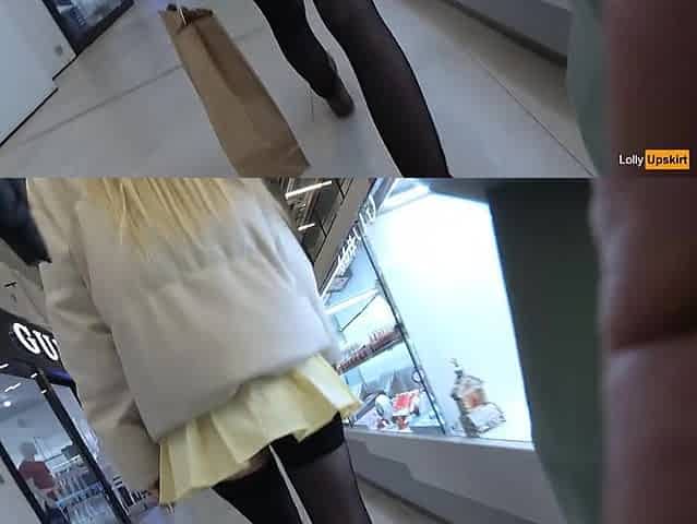 A girl walks in a short skirt without panties in a shopping mall