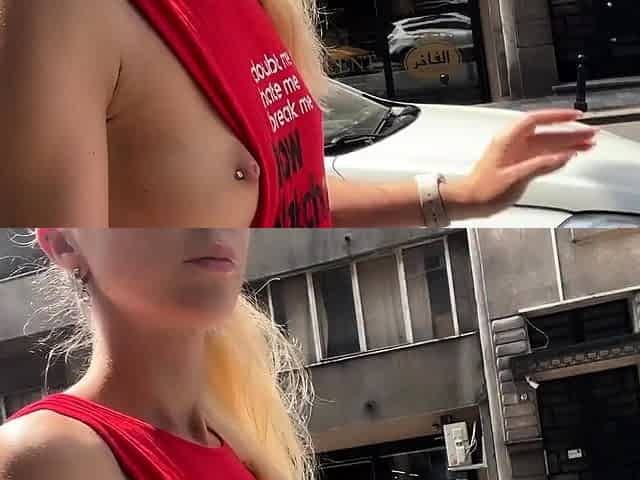 Braless walk in city. Flashing piercing nipples in public.