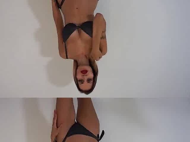 Erotic brunette hair in ebony underware showing body and tattoos