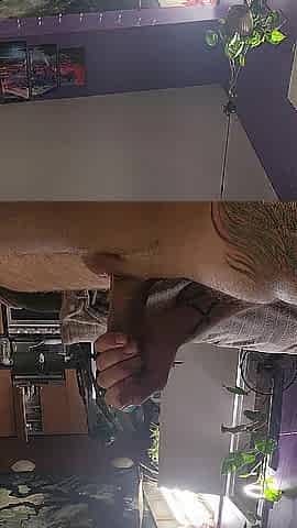 close up of large penis lubed up being stroked