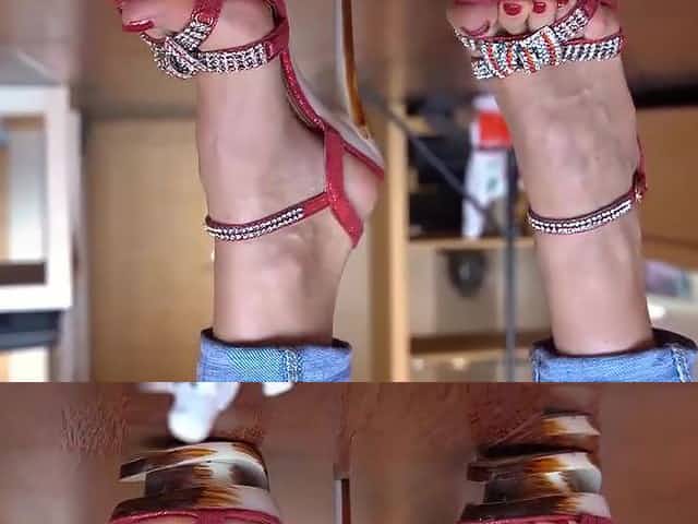 Close up on red hooker-porn strassy sandals. Red polish.