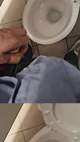 Pissing in public crapper with large cock