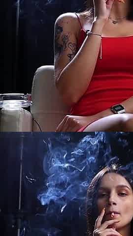 Sexy Lady in Red Is Smoking Two 100mm Reds