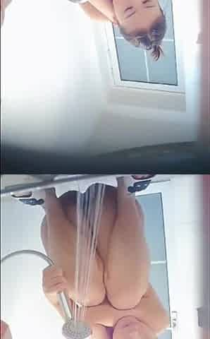 Chinese college girl taking a shower in the drom bathroom.