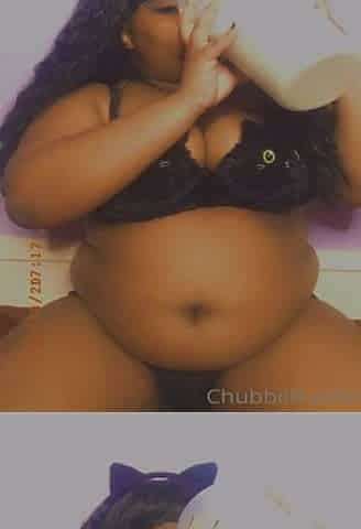 Black with an giant stomach drinking milk