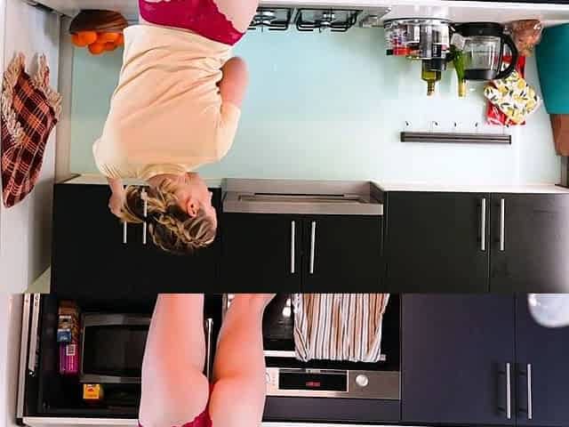 Pigtailed blondie plays with vibrator in the kitchen