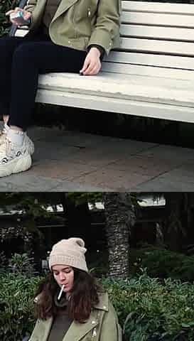 Young Brunette Is Taking an Unhurried Stroll with Allwhite 120mm Cigarette