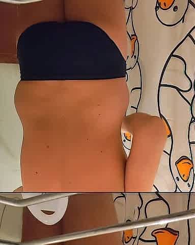 Taking a shower in my swimming trunks