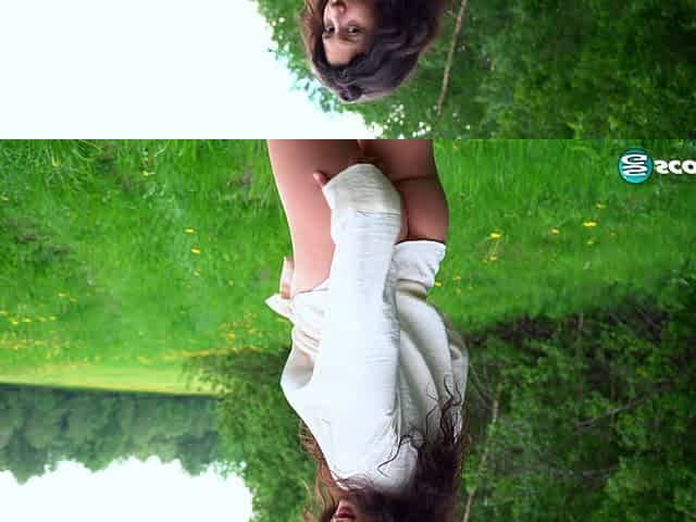 Busty teenage brunette Lola exposes her DD-cup tits in an open field and spreads her pussy for your pleasure.