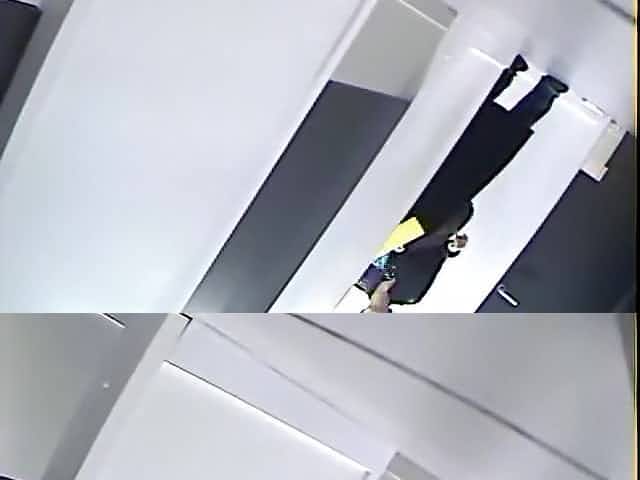 Spy cam in changing room shoots topless babe in jeans