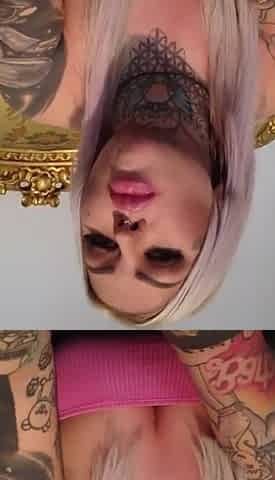 Tattooed blonde lady with a bubble gum