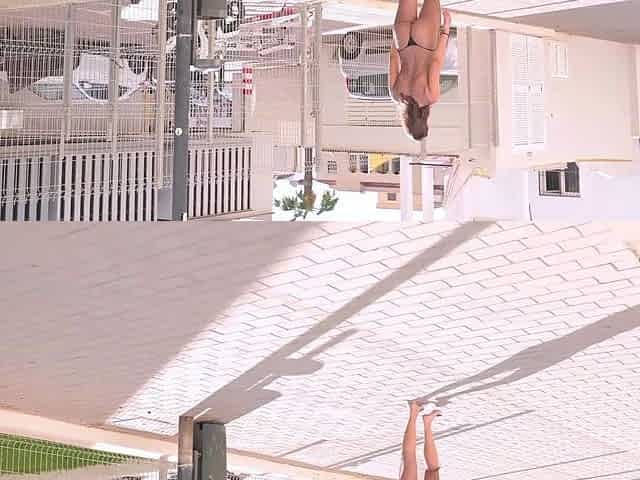 Sexy brunette Ellie walks and poses topless on the beach