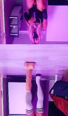 A hotty is dancing in front of a large dick