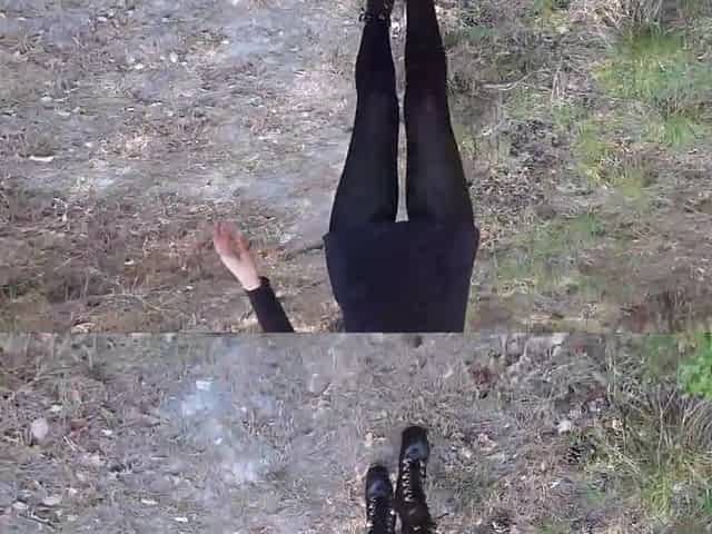 Walking on the wood wearing a ebony suit, hose and high heels ankle boots