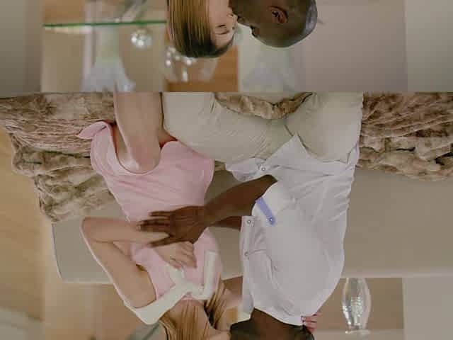Skinny babe gives a blowjob while being doggystyle fucked by a big black cock