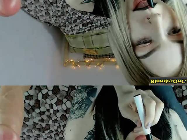 Blonde woman with black lipstick rubs her pussy
