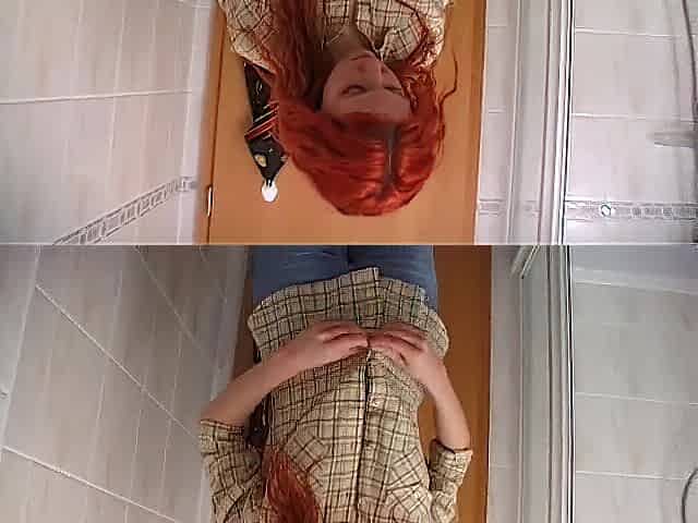 Redhead gal showering solo