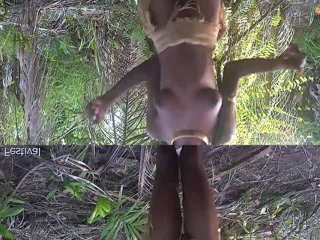 Consummate body darksome skin Afro village beauty dancing in Raffia half nude outdoor