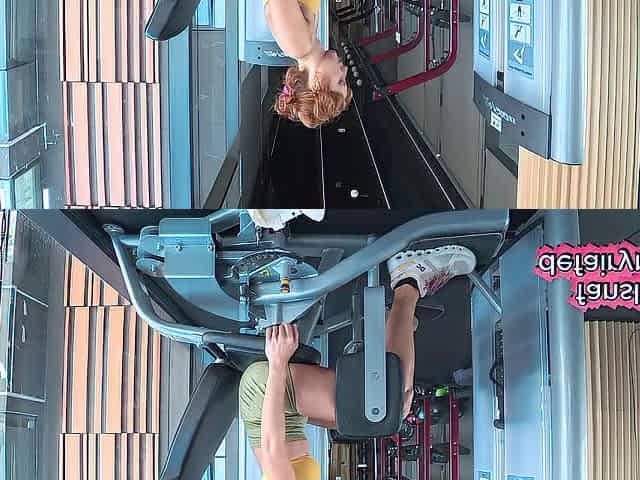 Redhead checking her taut gym outfit in the mirror for u