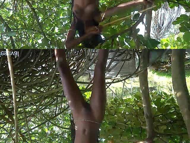 Naked skinny tribe woman making a bow to go hunting