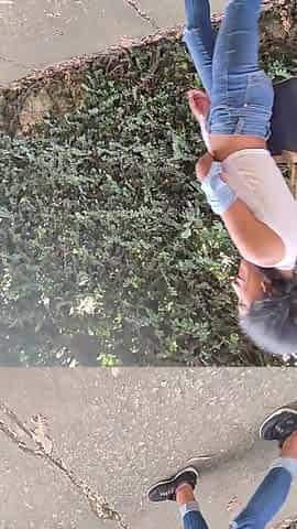 charming slim brunette hair is filmed by her boyfriend whilst this babe changes her blouse on the street
