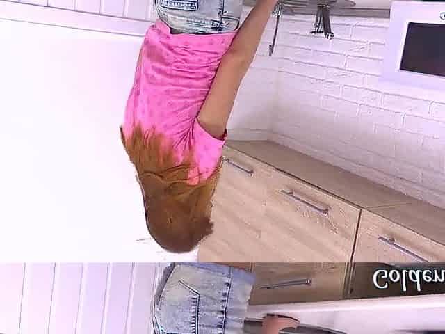 Redhead cutie masturbates her snatch in the kitchen