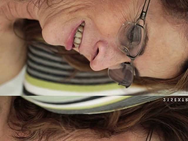 Granny with glasses smiles as the partner explores her inner depths