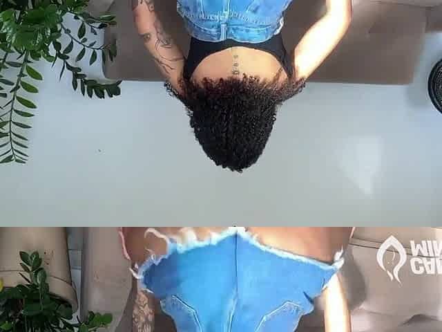 A hawt, married brunette hair shaking her large booty in constricted shorts.