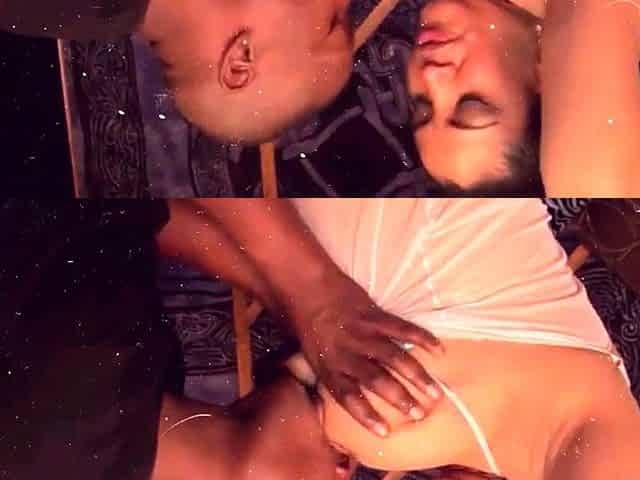 In a kitchen a sexy brunette playing with her big boobs