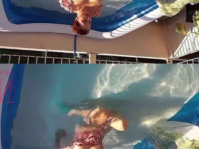 Elegant and supple chick, swimming underwater in the outdoor swimming pool. twenty one