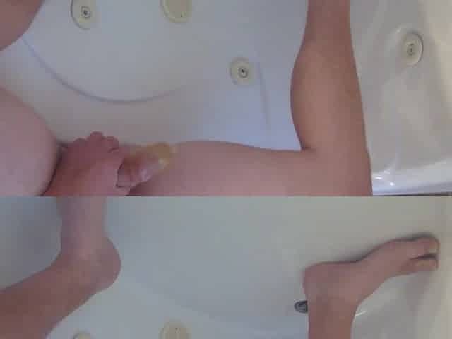 Pissing into a cock rubber in the bathtub