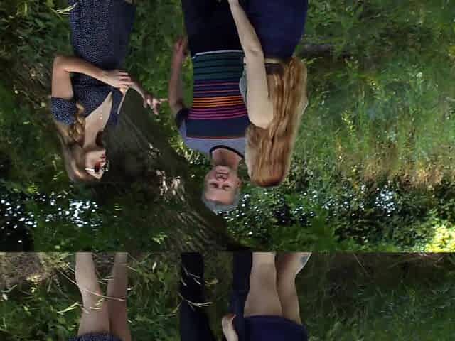Two girls have a threesome with a guy in the forest.