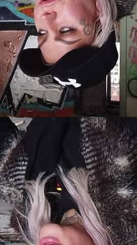 Blonde lady smokes an electronic cigarette on stair