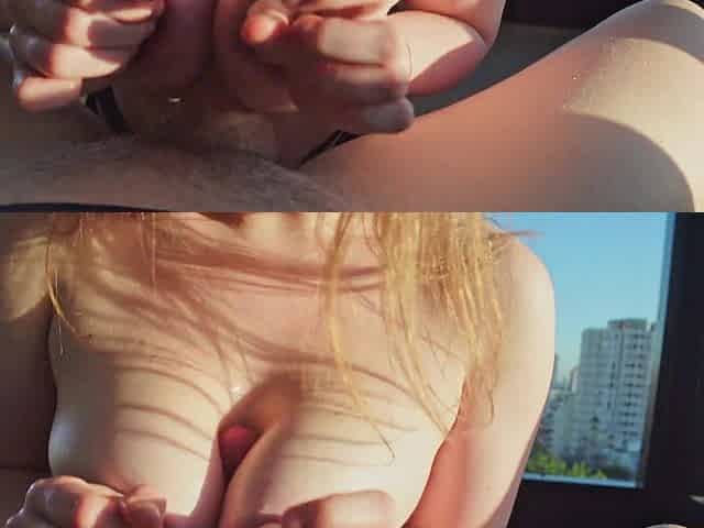 Stunning blonde babe with big tits enjoys passionate titjob by city window