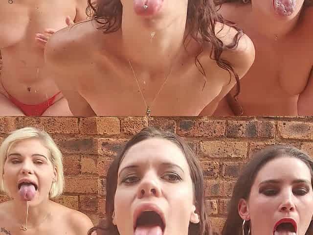 three strumpets sit outside with their tongue's out playing with spit