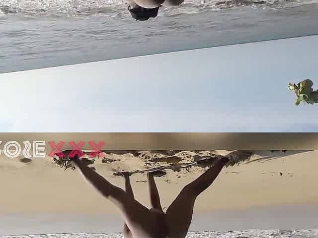Black woman exercising nude on the beach