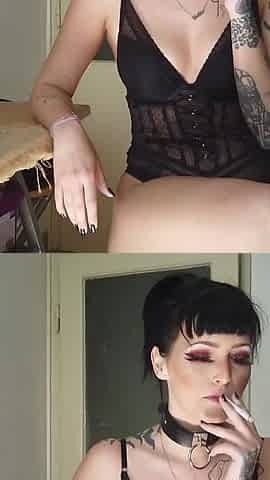 Tattooed gothic lady smoking in the kitchen